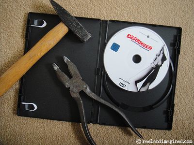 Hammer and pliers lying on a DVD case