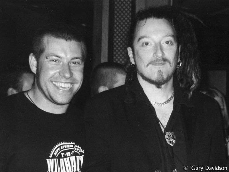 `Gary Davidson with Ginger Wildheart at the Fez Club, Reading, 21 September 2003. Gary pinched Ginger's side to try to make him smile (something he apparently didn't like to do in photos).