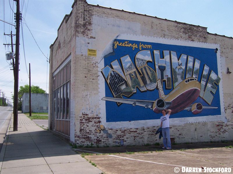 Darren by the 'Greetings from Nashville' mural